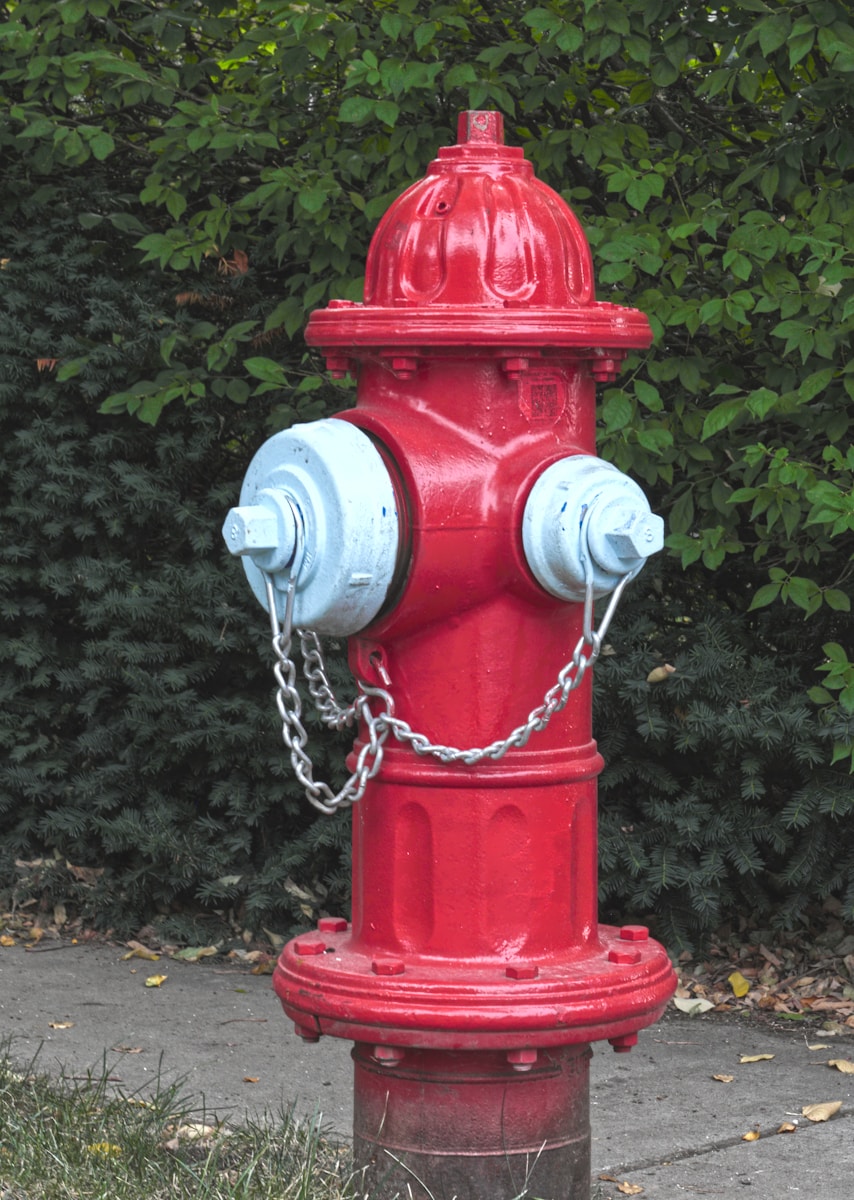 a red fire hydrant with a chain around it