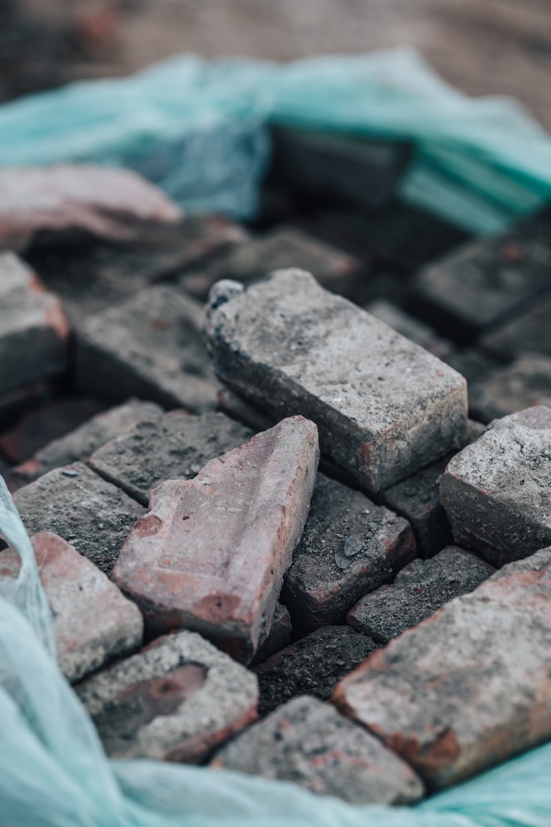 a pile of bricks sitting on top of a plastic bag